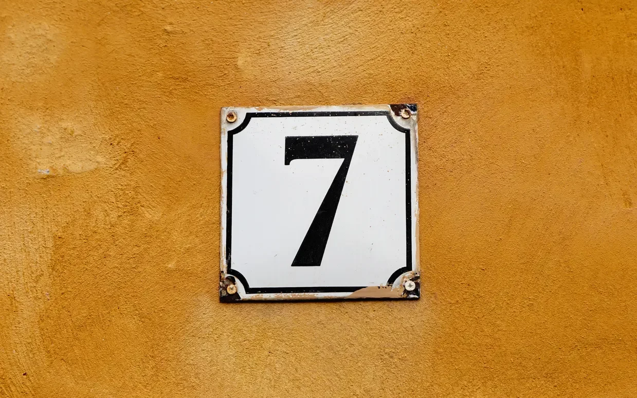 Number 7 sign on a wall.
